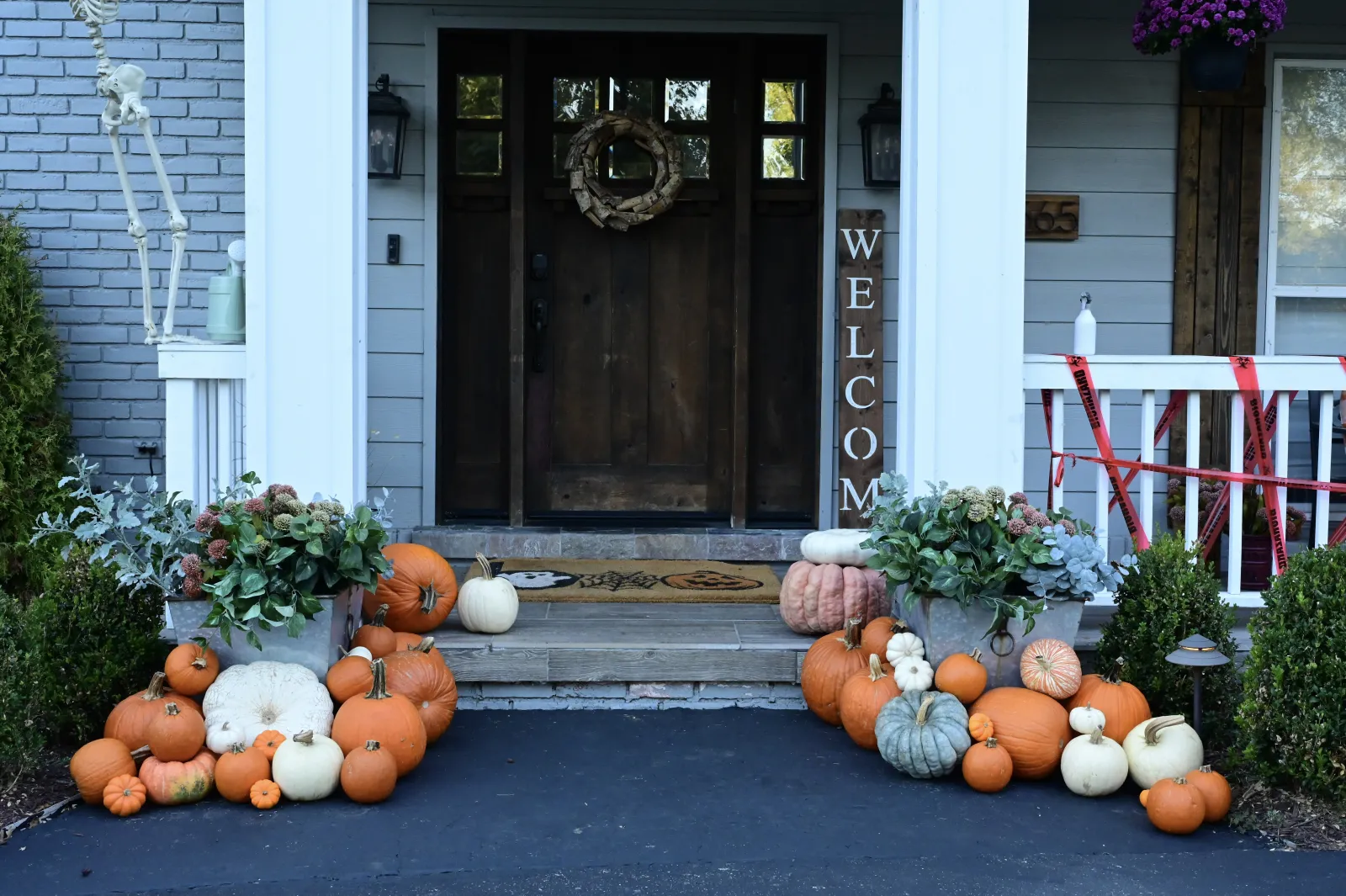 Halloween porch decorating with skeleton and pumpkin display in Huntington Woods MI